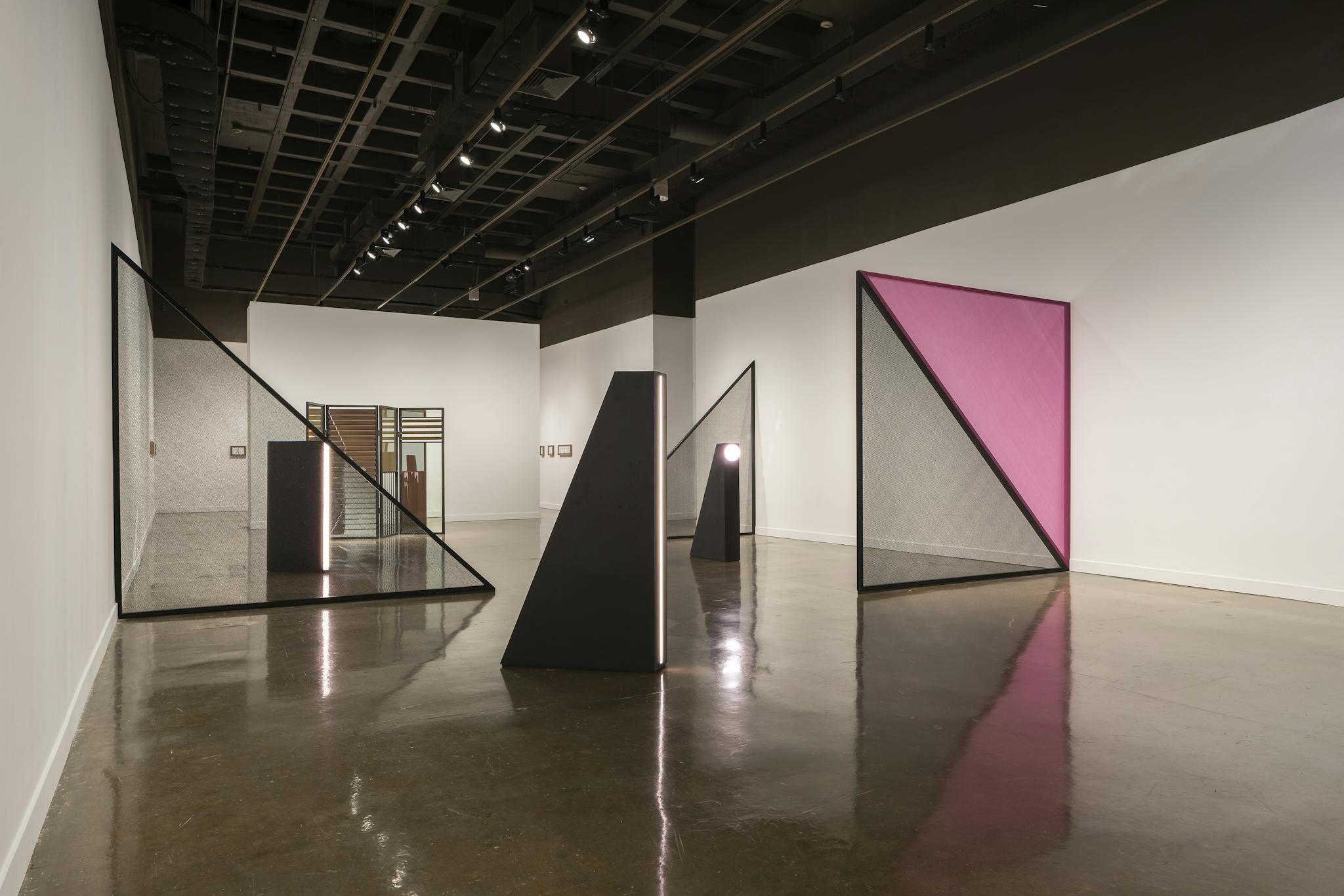 Black and pink dividers are distributed across the room at the MIT List Visual Art Center.