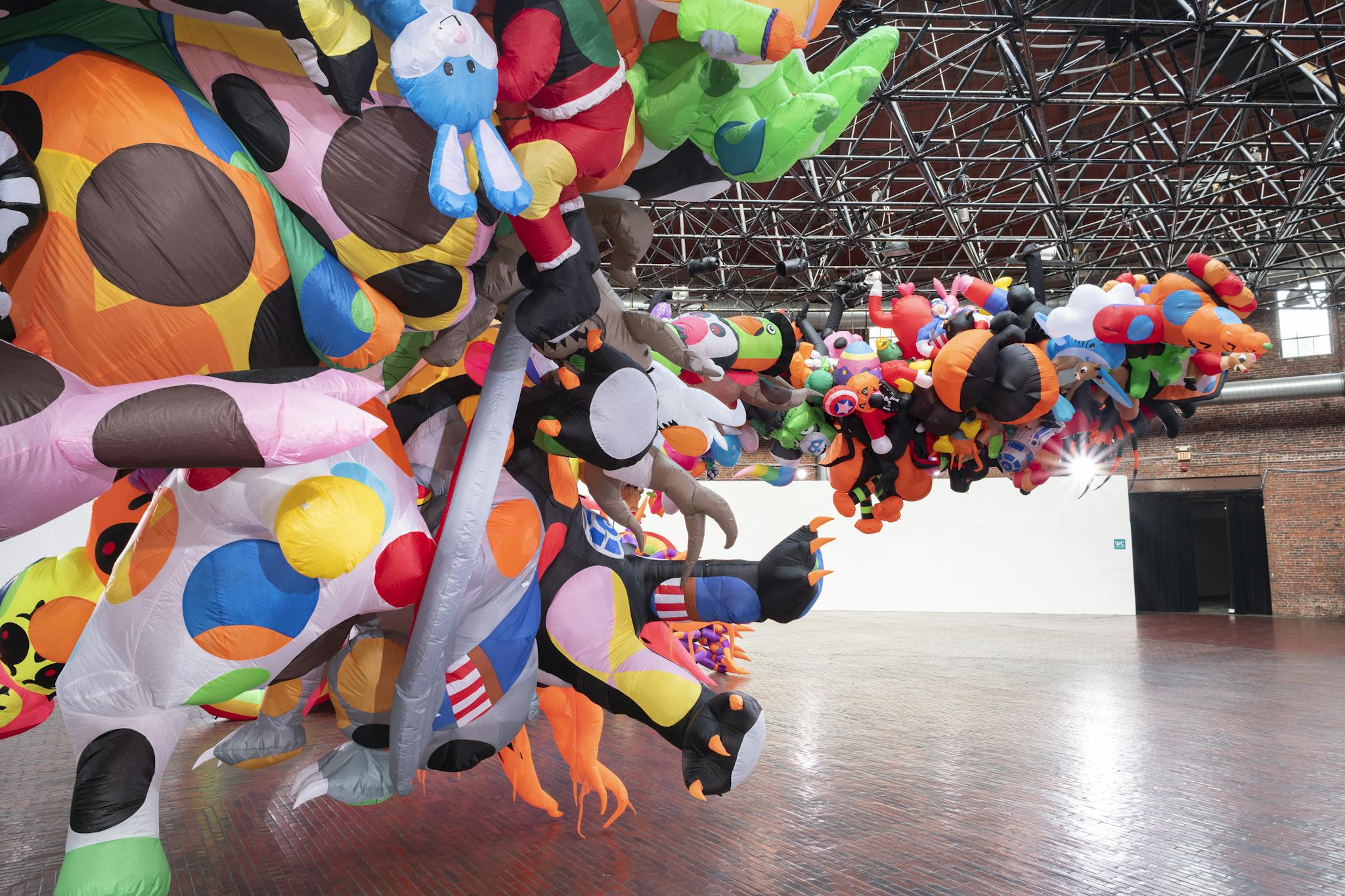 An abundance of colorful, inflatable figures hanging in the Cyclorama.