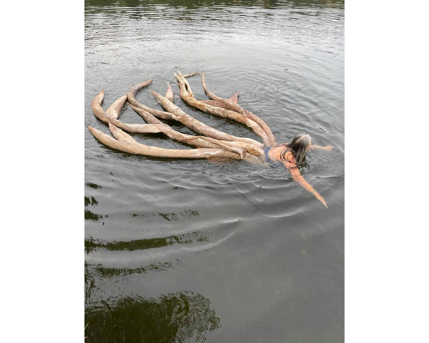 A woman with tentacles swims in the water in Caroline Bagenal's image.