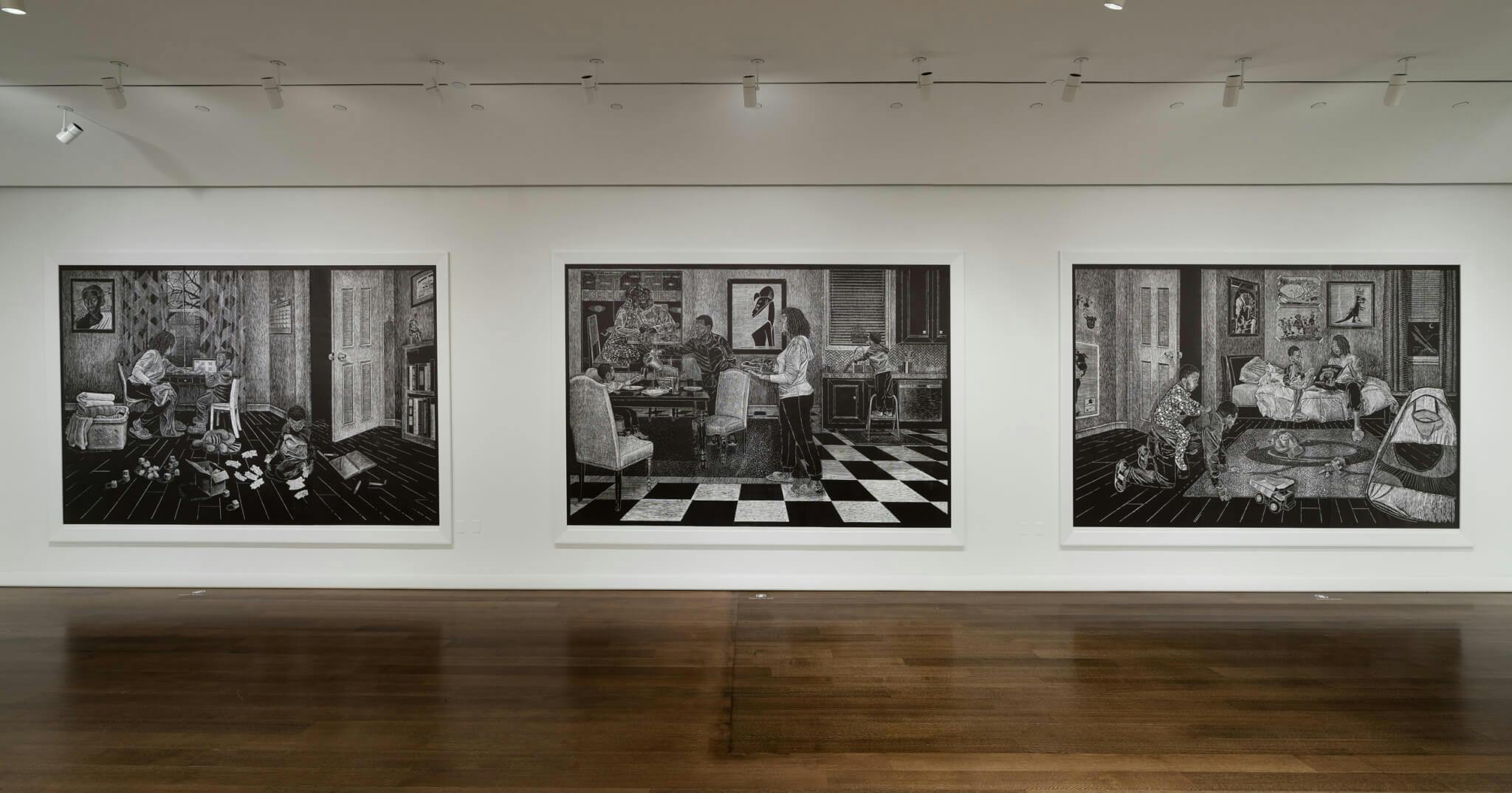 An installation view of three black-and-white works on a white wall.