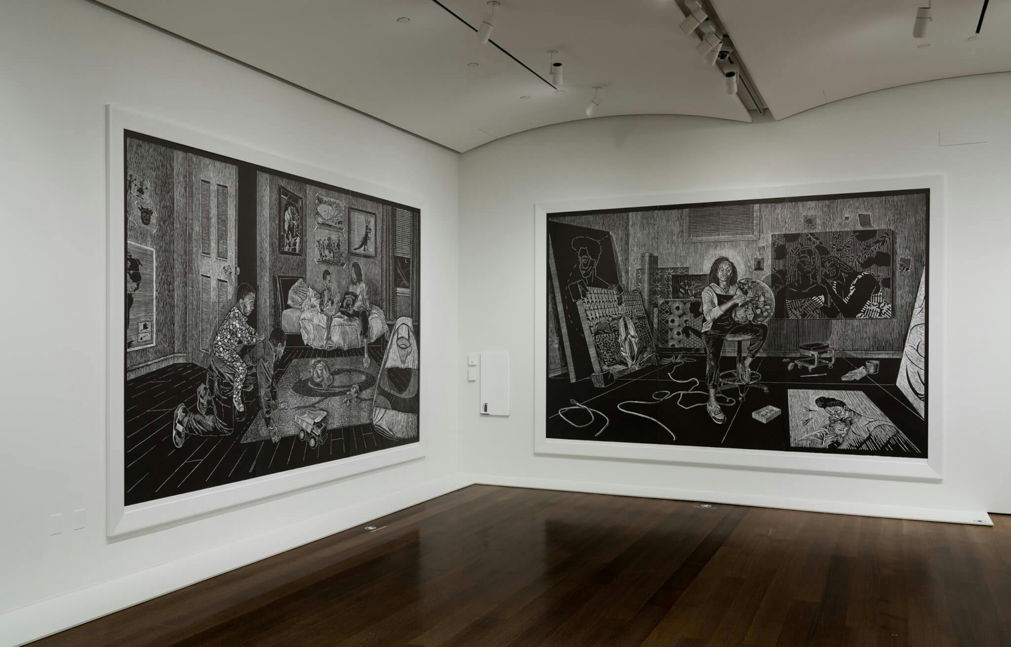 An installation view of a corner with black-and-white works on both walls.