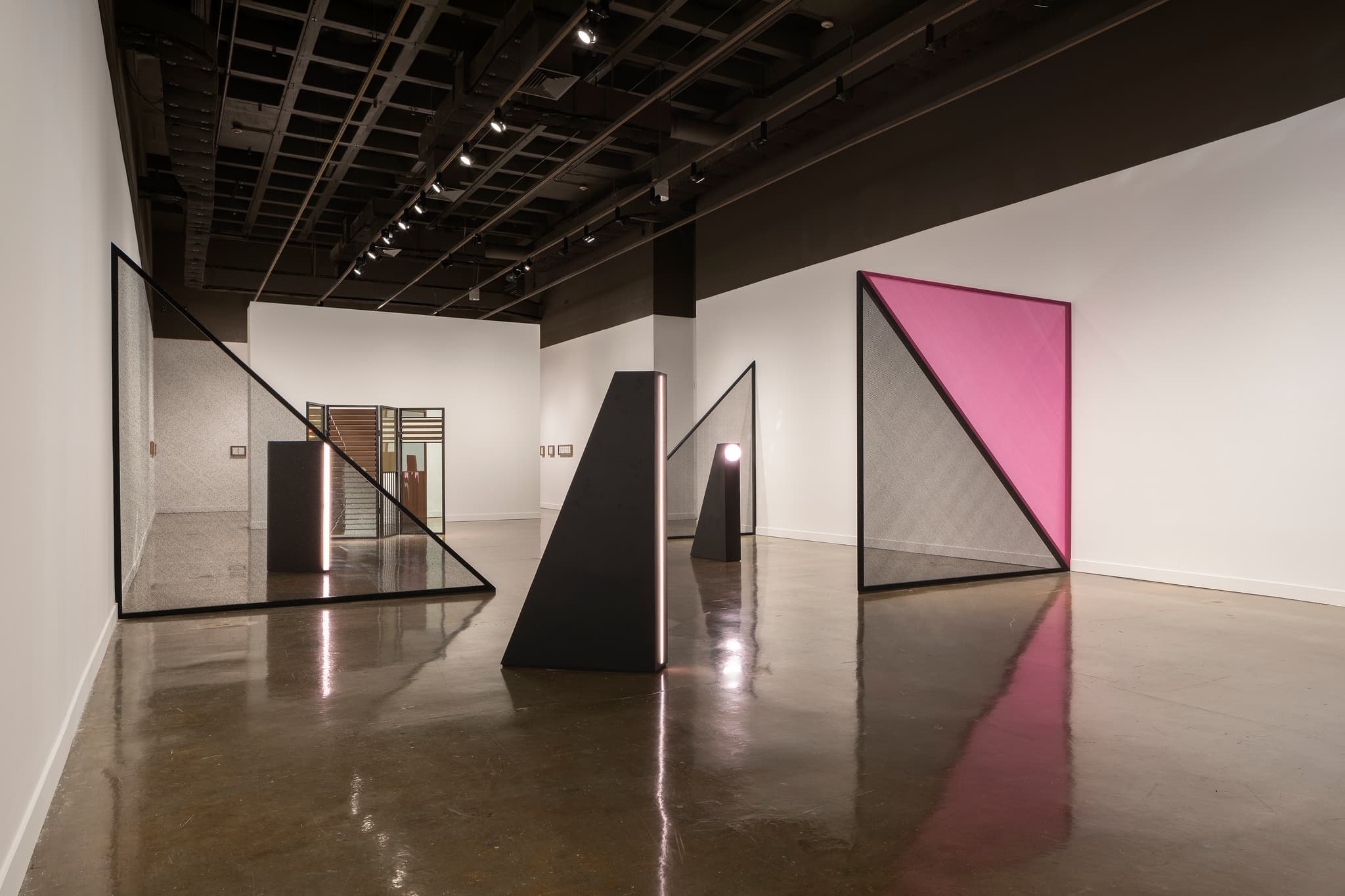 Black and pink dividers are distributed across the room at the MIT List Visual Art Center.