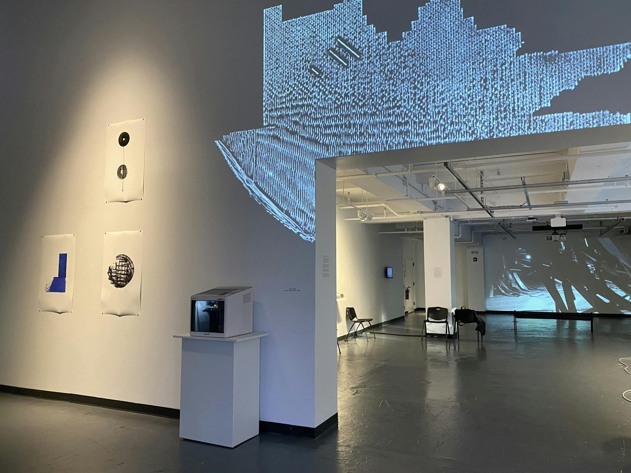 A projection against the wall illuminates the space at the Emerson Contemporary Media Art Gallery.