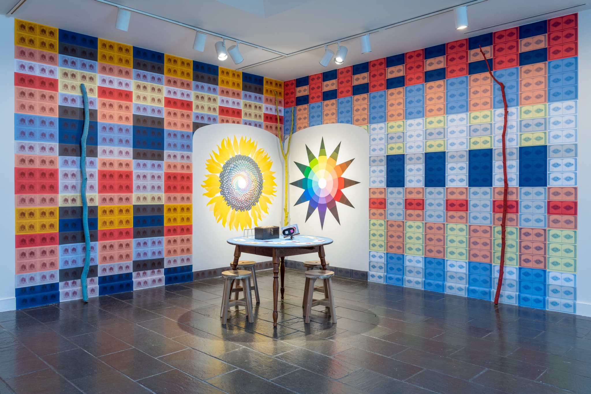 A bright sunflower and the image of a rainbow color wheel are featured in Maria Molteni's work.