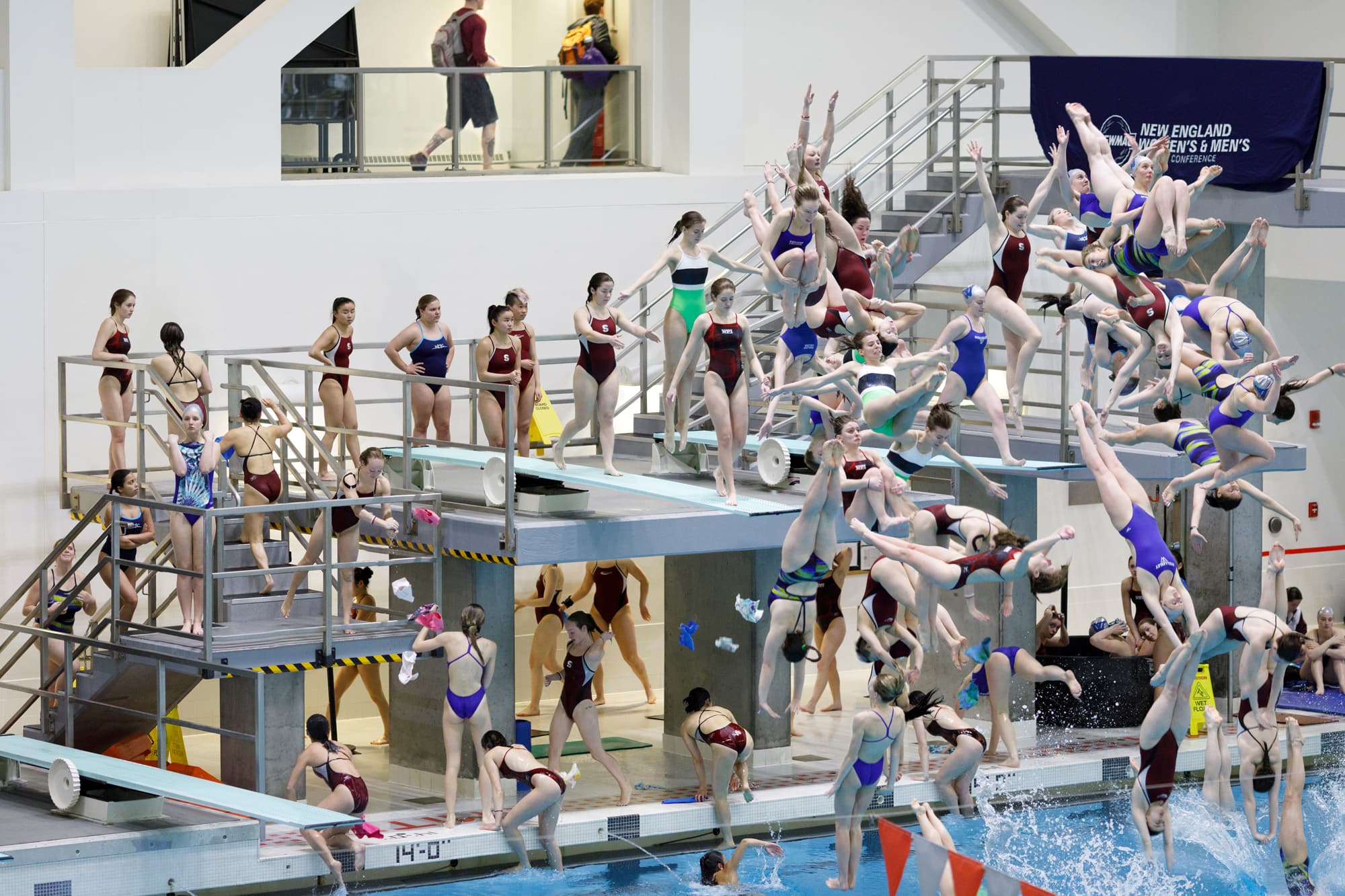 An artwork by Pelle Cass displays swimmers diving into a pool and assembled on a staircase nearby.