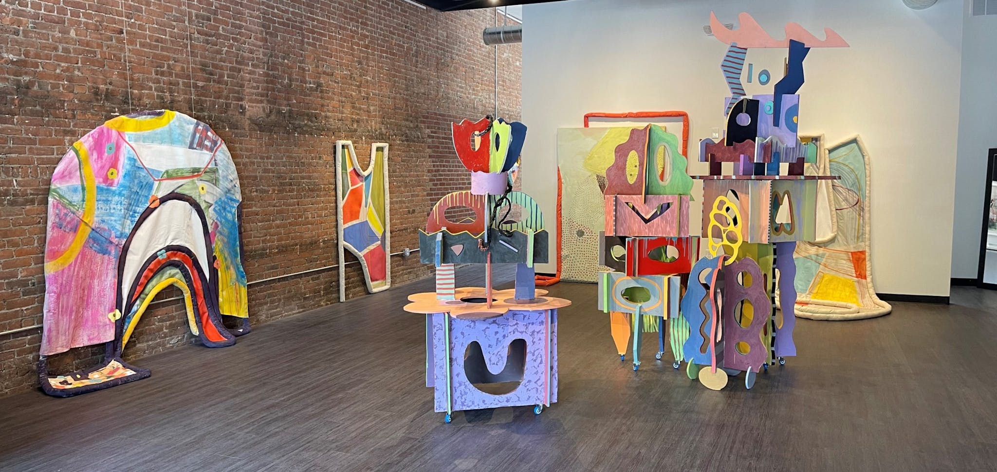 Colorful structures are positioned across the room, suggesting a play space.