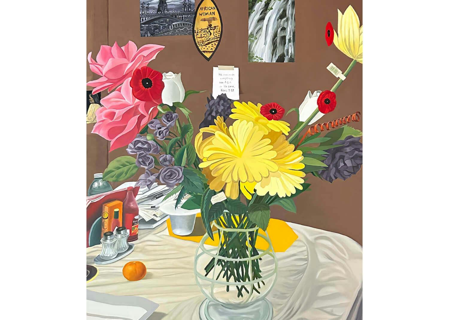 A painting of multicolored poppies in a glass vase. It sits atop a cluttered table in front of a brown wall decorated with posters.