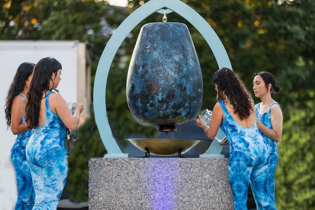 Four artists during an outdoor performance.